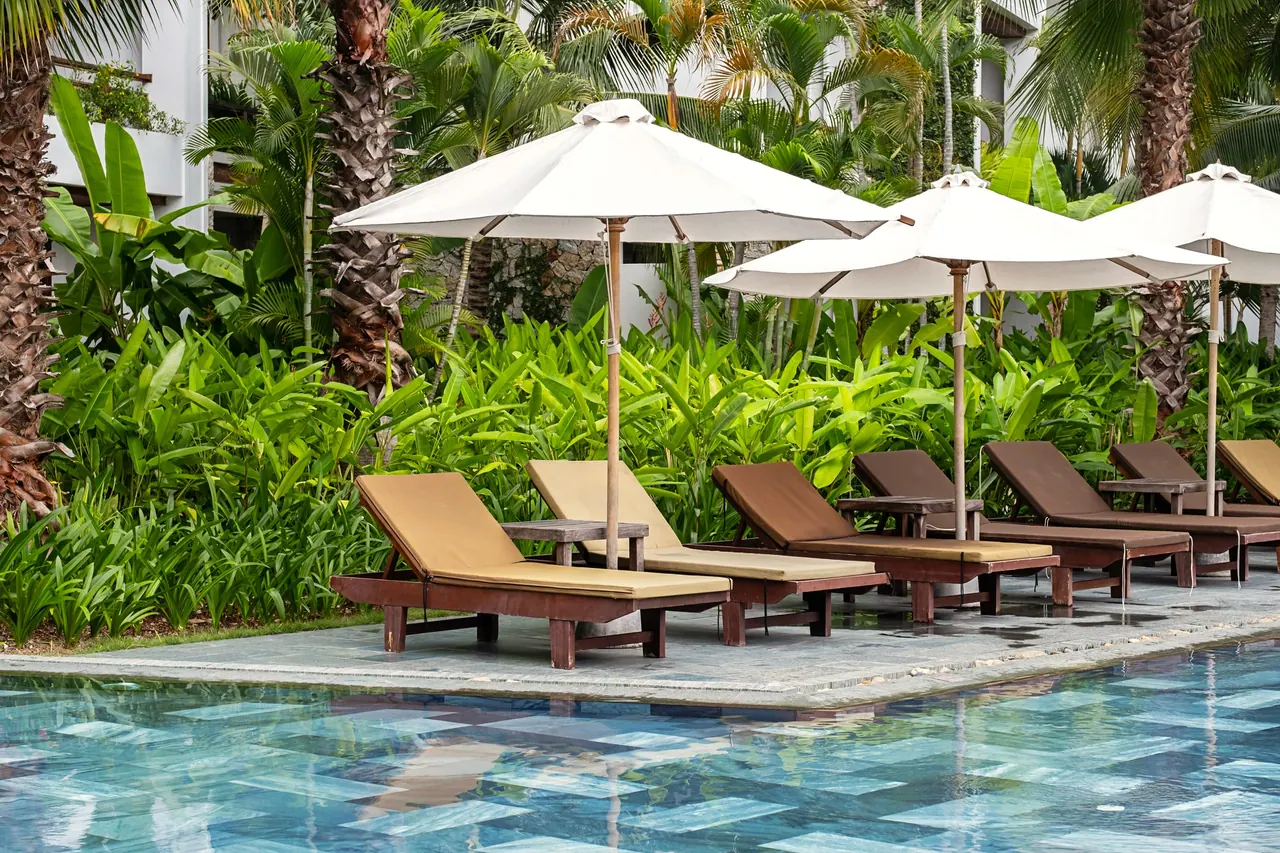 Pool deck with umbrellas and palms